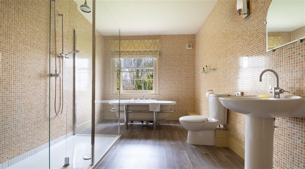 One of the bathrooms with freestanding bath and walk-in shower at Gunby Old Rectory in Skegness, Lincolnshire