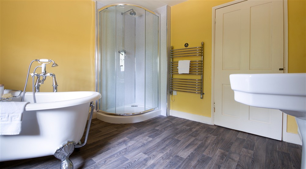The second bathroom with roll-top bath and freestanding shower at Gunby Old Rectory in Skegness, Lincolnshire