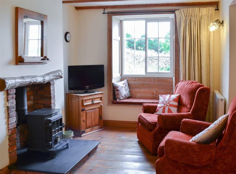 Cosy and inviting living area with woodburner at Gunluck Cottage in Brompton by Sawdon, North Yorkshire