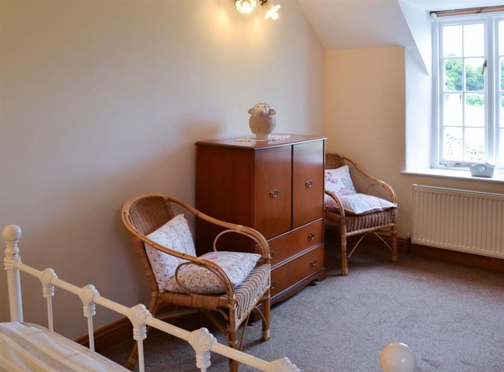 Double bedroom with sloping ceiling at Gunluck Cottage in Brompton by Sawdon, North Yorkshire