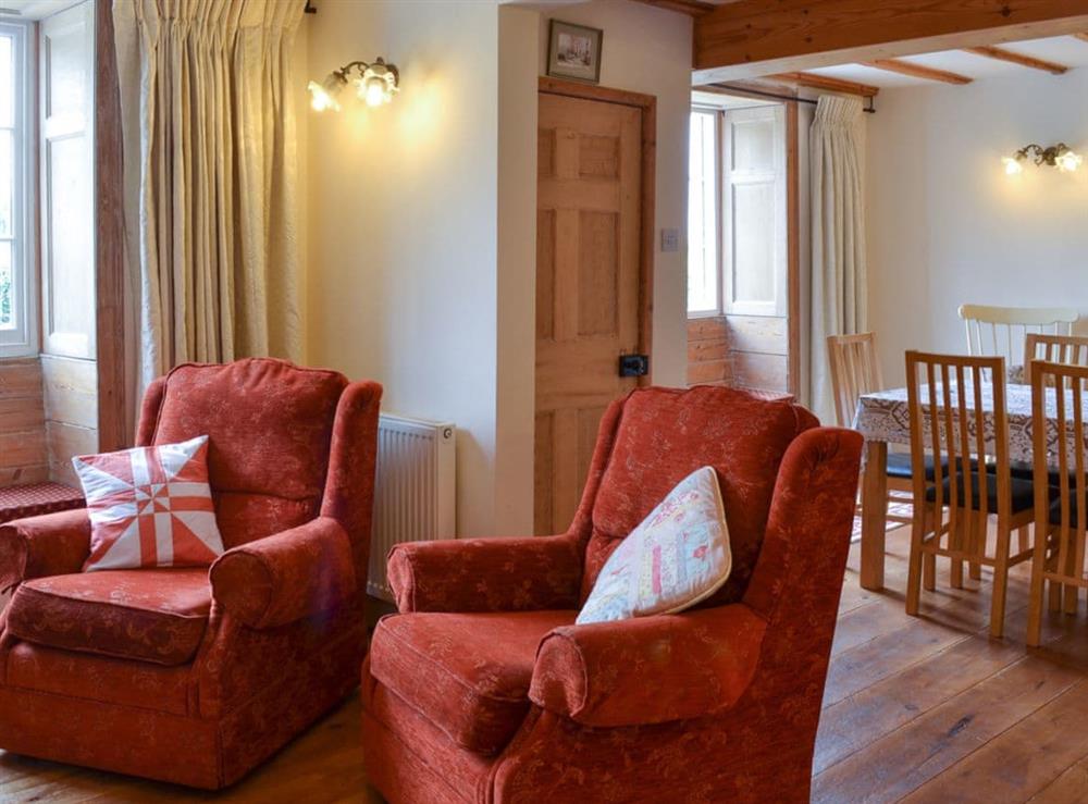 Lovely beamed living/dining room at Gunluck Cottage in Brompton by Sawdon, North Yorkshire