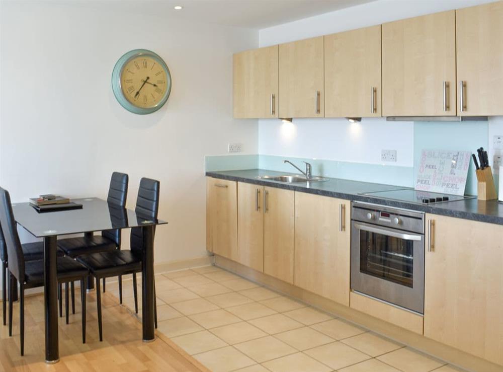 Fully appointed kitchen with dining area at The Two Bedroom Balcony View A, 