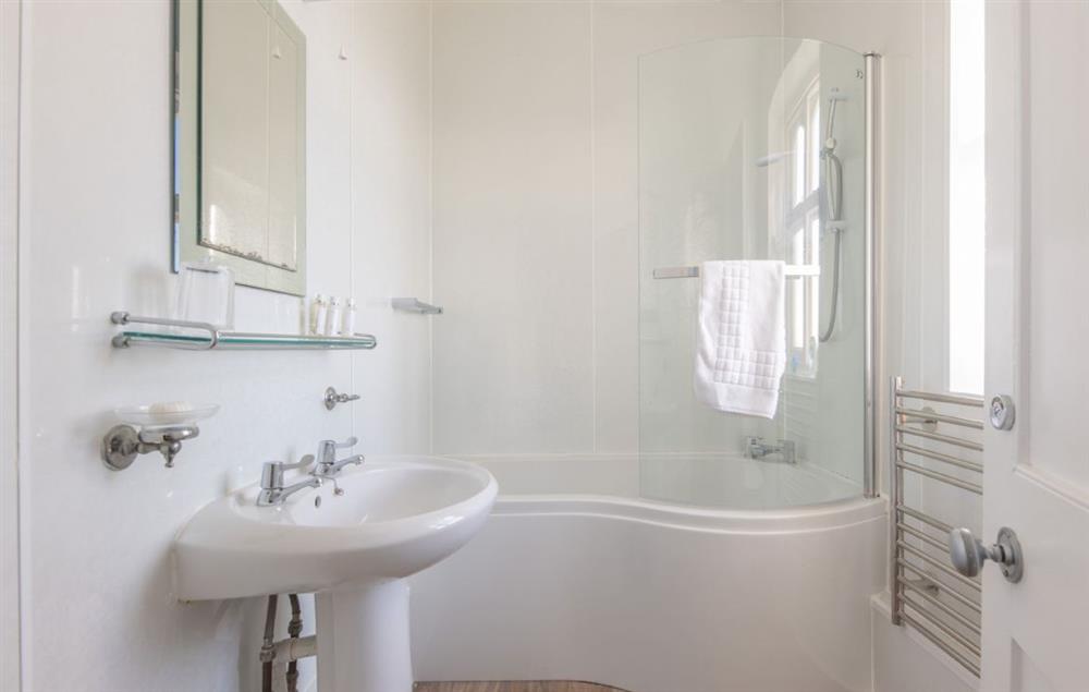 Bathroom with bath and shower over at Gurnard Cottage, St Catherines Lighthouse