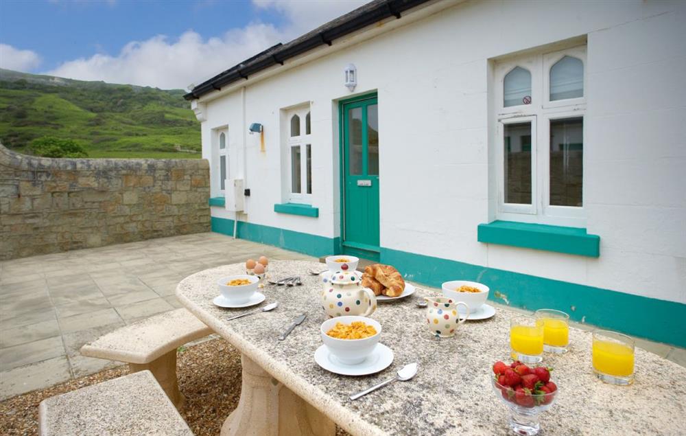 Private enclosed courtyard with garden furniture at Gurnard Cottage, St Catherines Lighthouse