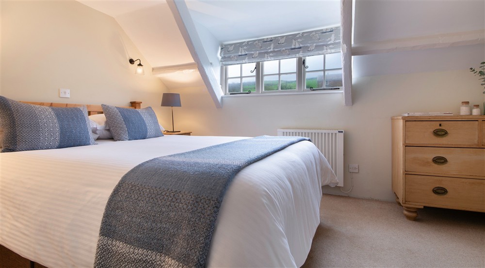 One of the double bedrooms at Guy's Cottage in Port Quin, Cornwall