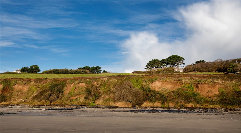 The view from Carne Beach towards Gwendra Wartha and other nearby holiday cottages, Cornwall at Gwendra Dairy Cottage in Truro, Cornwall