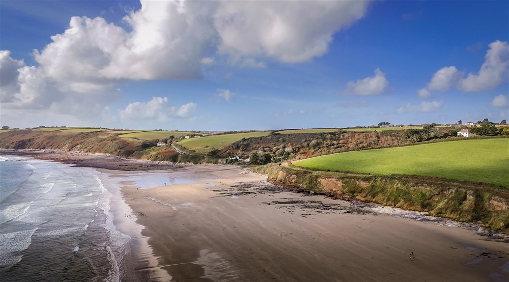 An aerial view of Pendower, a sand beach that is a short walk from the Gwendra cottages, Cornwall at Gwendra Wartha in Truro, Cornwall