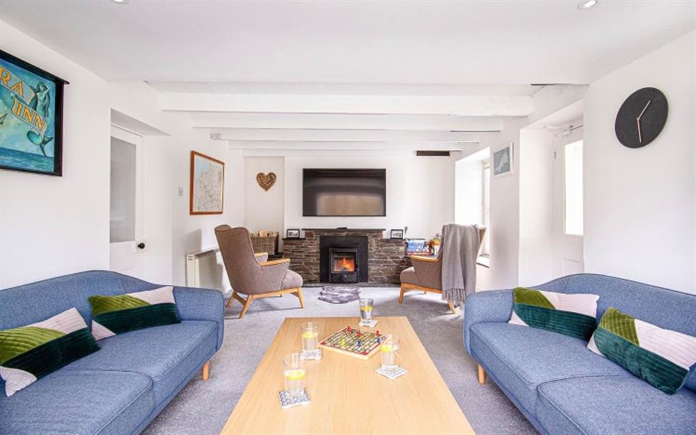 Open plan sitting room with cosy wood burner at Camel Trail, 