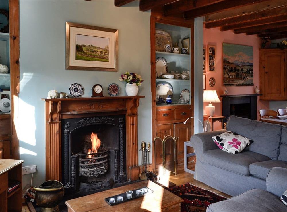 Cosy living room with open fire at Gwernol in Dolwyddelan, near Betws-y-Coed, Conwy, Gwynedd