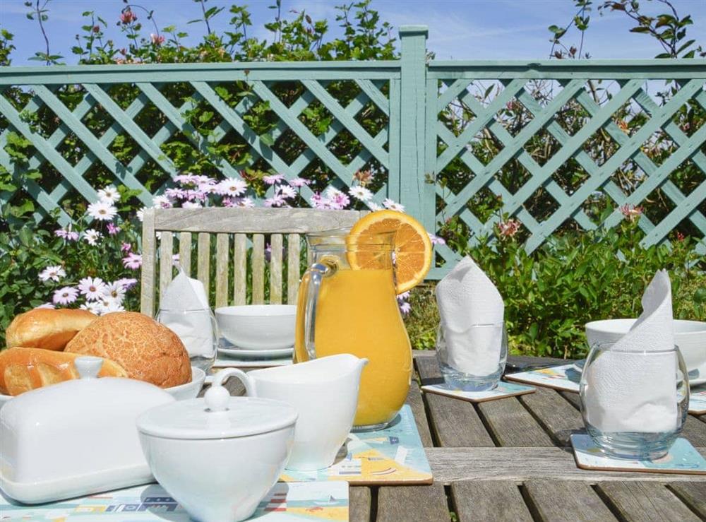 Breakfast area in the southwest facing garden at Haddock’s End in Pendeen, Penzance, Cornwall., Great Britain