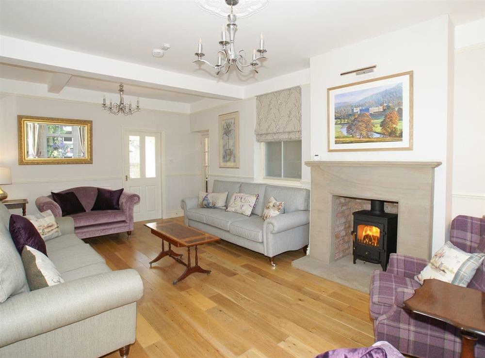 Welcoming living room with wood burner at Haddon Villa in Bakewell, Derbyshire