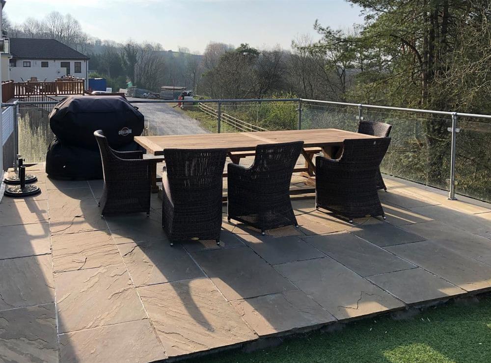 Paved patio area with seating at Hafan Dawel in Stepaside, near Saundersfoot, Pembrokeshire, Dyfed