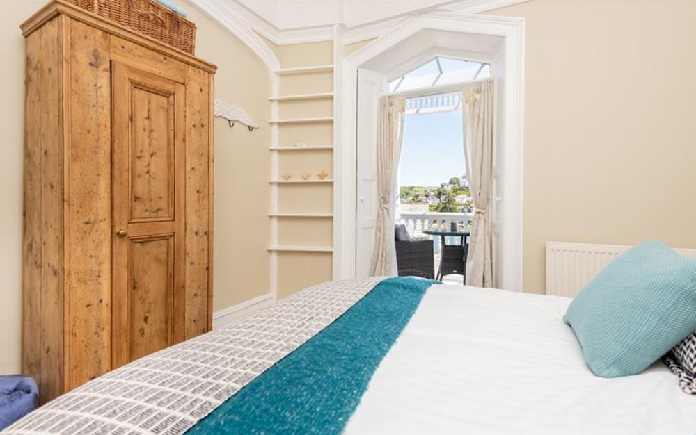 Bedroom two with 5ft king size bed and french doors leading to front river facing balcony. at Halcyon House in Dartmouth