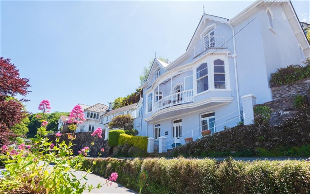 Grand period property with iconic bay windows and front balcony.