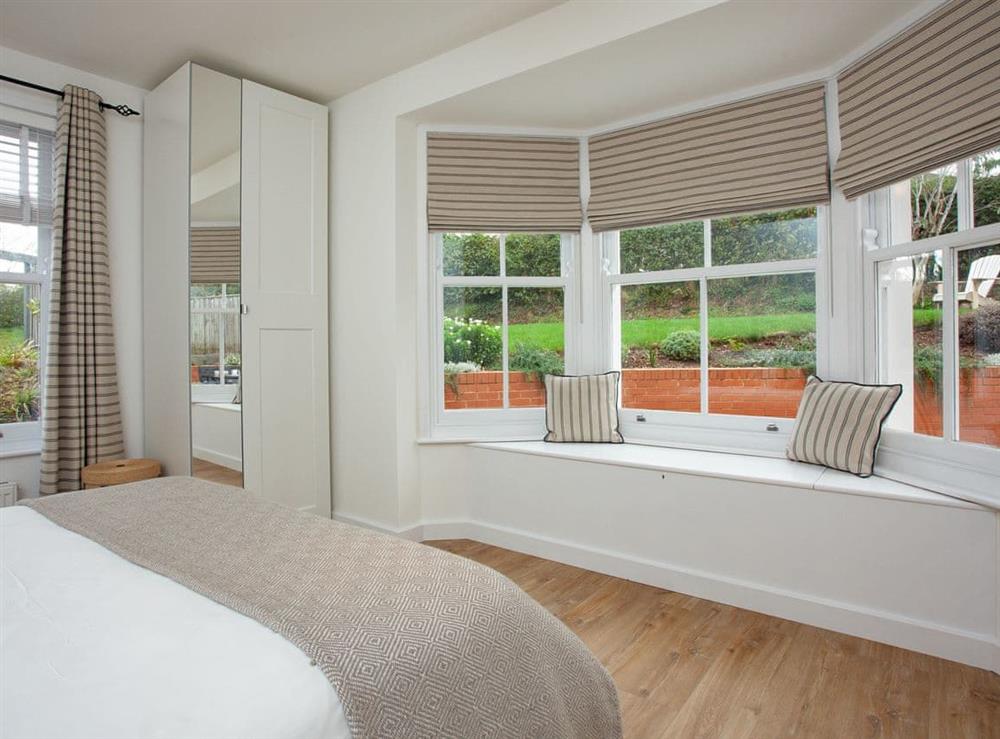 Bedroom with king size bed and en suite at Haldon View in Lympstone, Devon
