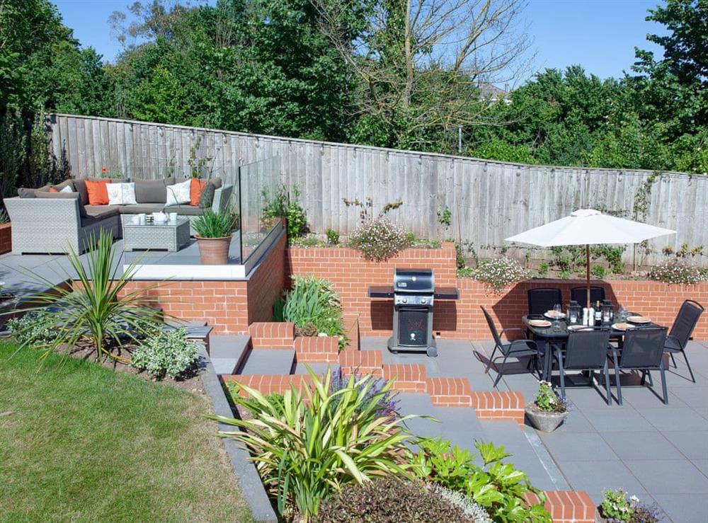 Garden with private enclosed patio and upper patio seating at Haldon View in Lympstone, Devon