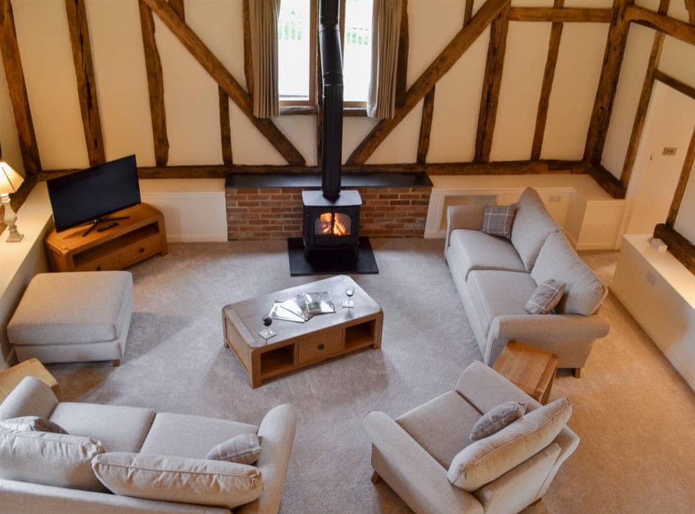 Cosy living room with exposed wooden beams at Hale Barn in Chiddingly, near Hailsham, East Sussex