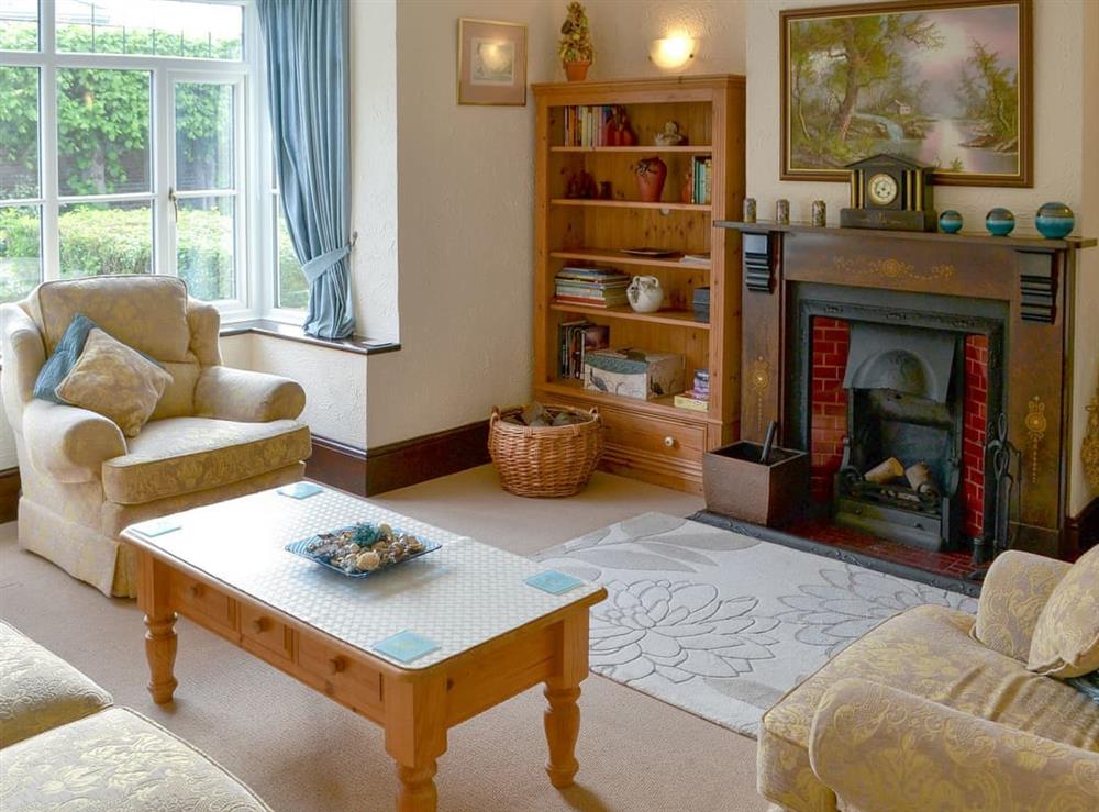 Cosy living room with an open fire at Half Moon Cottage in Great Yarmouth, Norfolk