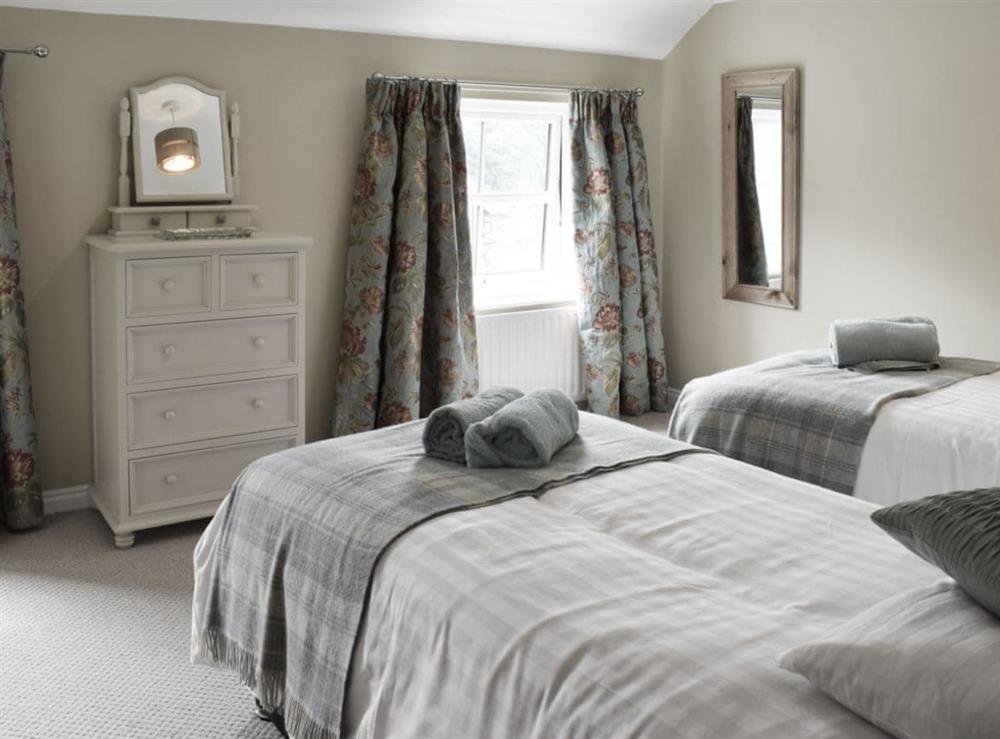 Inviting bedroom with twin beds at Halfehill Cottage in Richmond, North Yorkshire