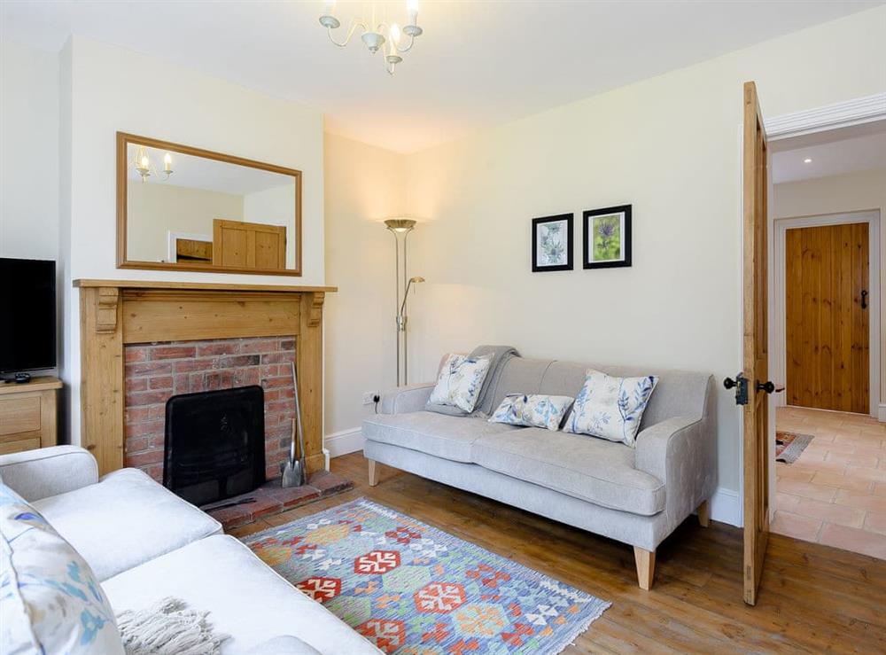 Cosy living room with wood burner (photo 2) at Sea Holly Cottage, 