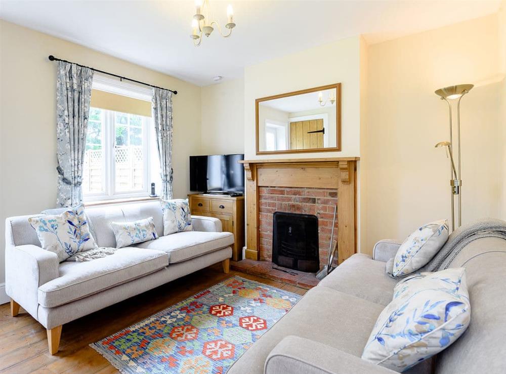 Cosy living room with wood burner at Sea Holly Cottage, 