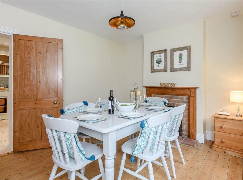 Dining room with wooden floor at Sea Lavender Cottage, 