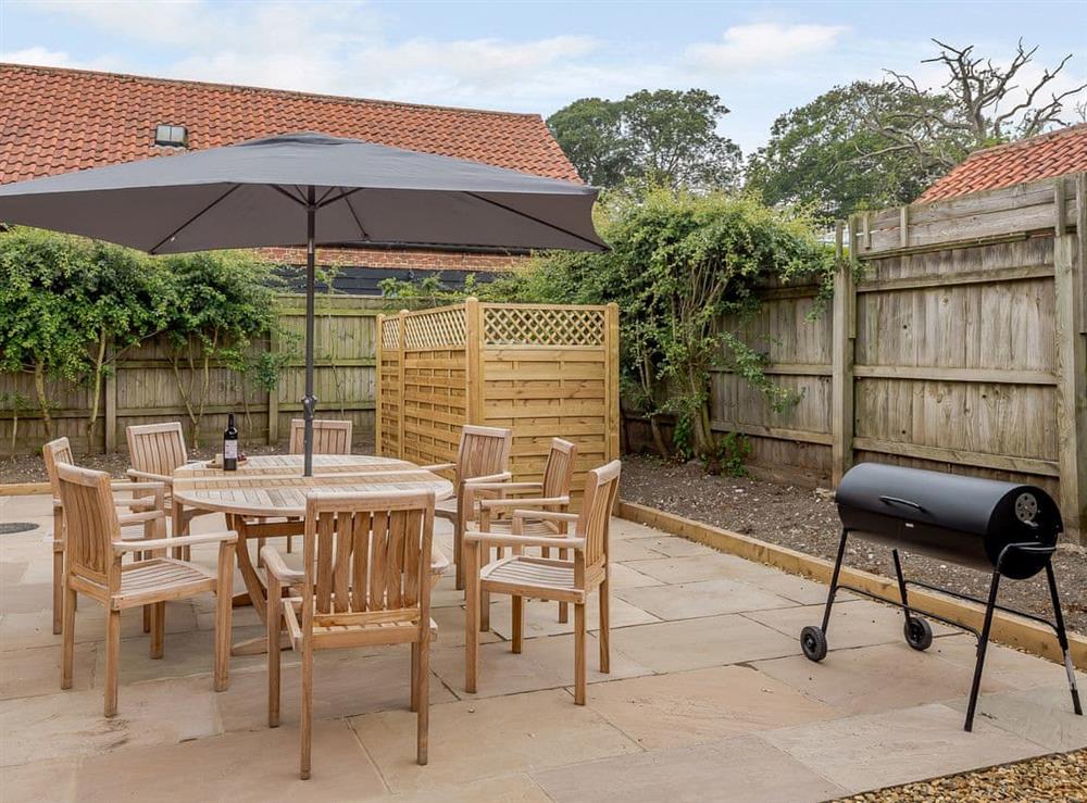 Enclosed courtyard with sun deck, garden furniture and BBQ (photo 2) at Sea Lavender Cottage, 