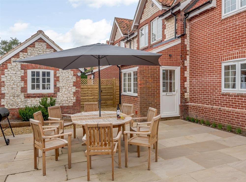 Enclosed courtyard with sun deck, garden furniture and BBQ at Sea Lavender Cottage, 