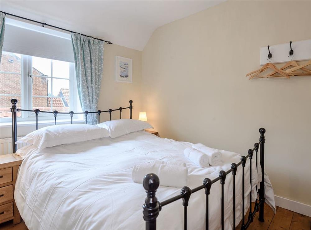 Tranquil bedroom with kingsize bed at Sea Lavender Cottage, 