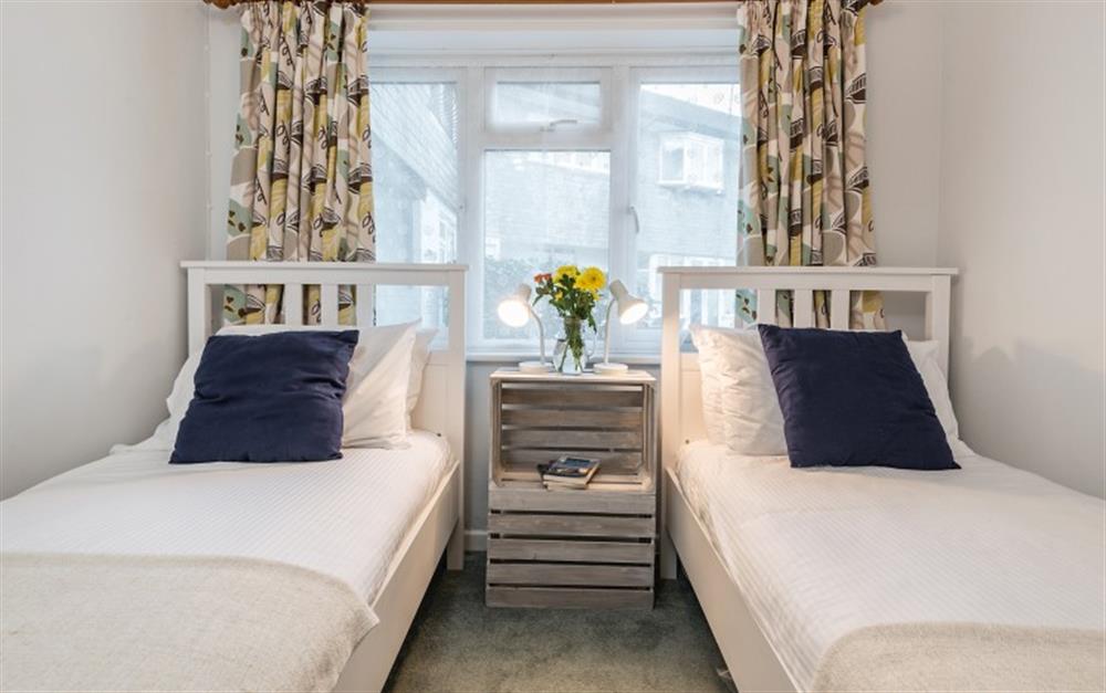 The curtains and cushions look good against the white walls. at Halliards in Helford Passage