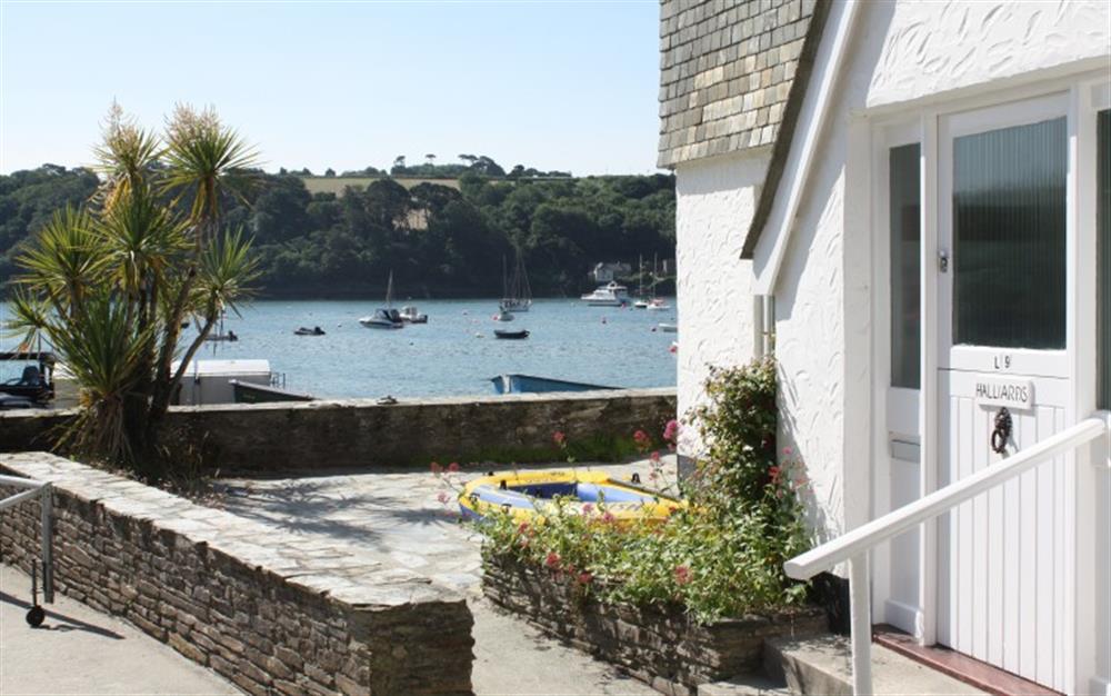The front door and wrap round patio, which has great river views. at Halliards in Helford Passage
