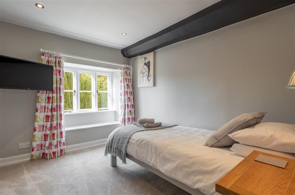 First floor: Bedroom three with a single bed and Smart television at Ham Farm, Sydling St Nicholas