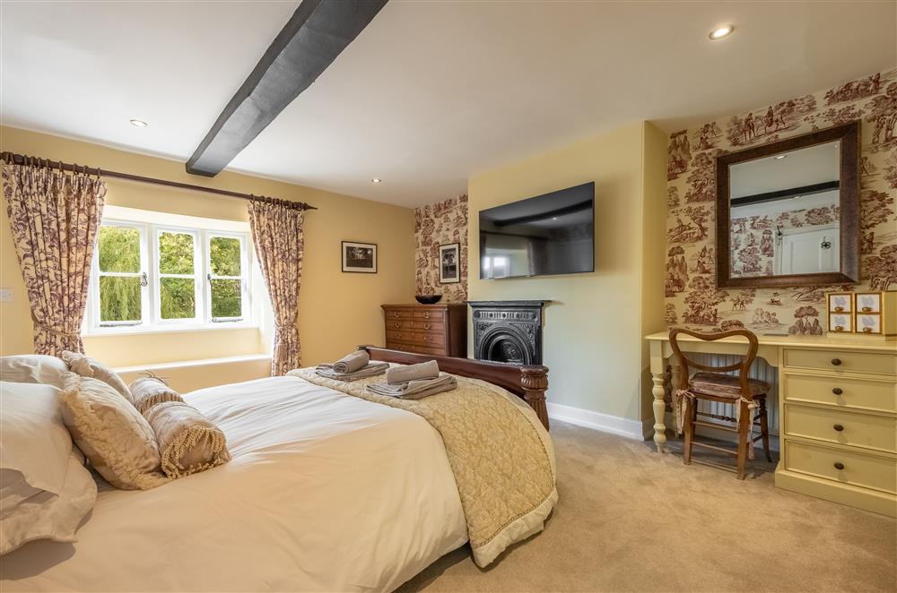 First floor: Bedroom two with a king-size bed and en-suite shower room  at Ham Farm, Sydling St Nicholas