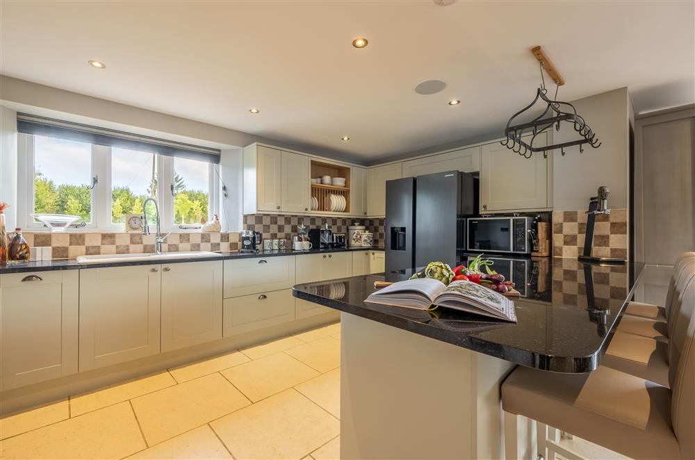 Ground floor: Kitchen area is well-equipped and has a breakfast bar and four stools  at Ham Farm, Sydling St Nicholas