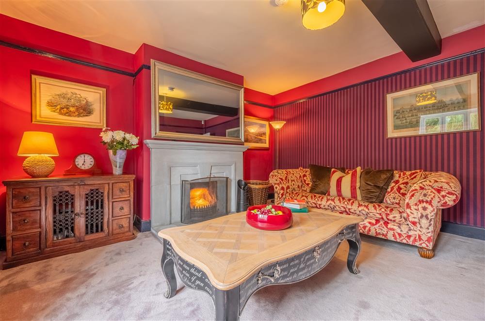 Ground floor: Sitting room with open fire and large mirror frame television