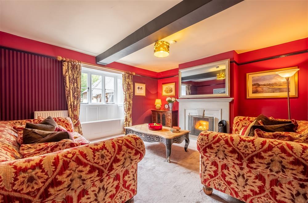 Ground floor: Sitting room with open fire and large mirror frame television at Ham Farm, Sydling St Nicholas