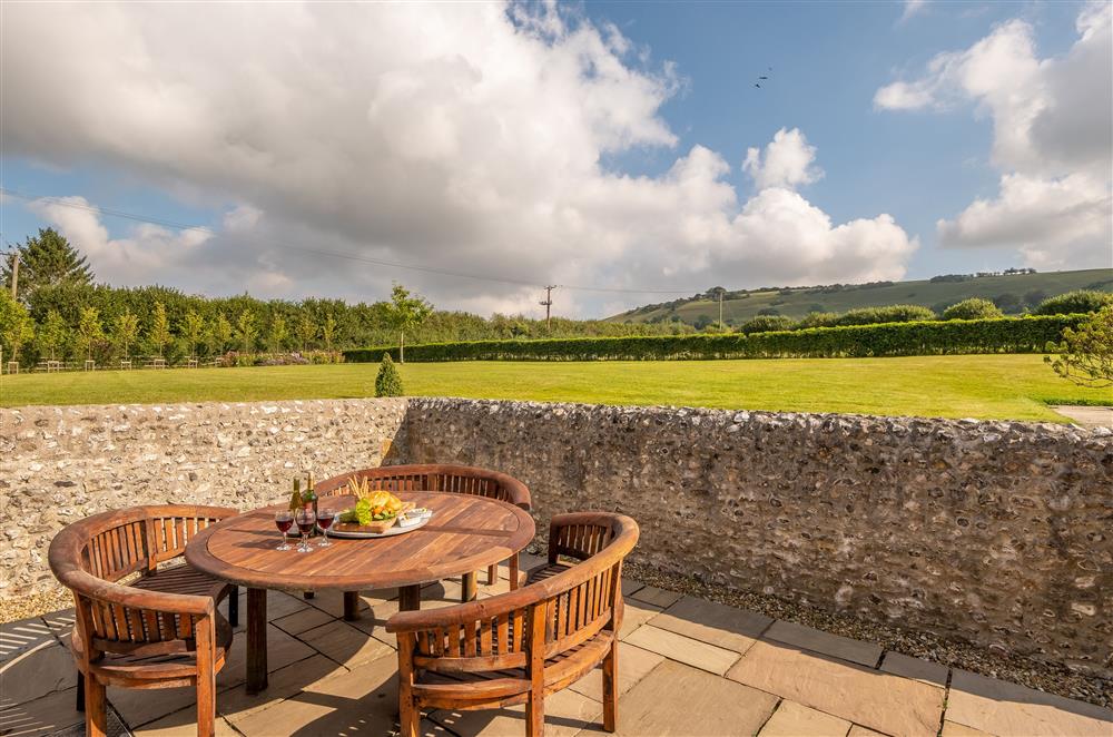 The dining table and benches are perfectly situated for enjoying the views at Ham Farm, Sydling St Nicholas