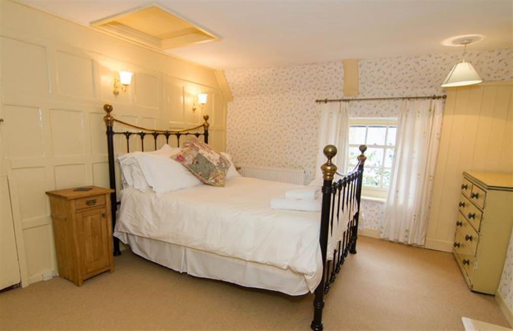First floor:  Master bedroom with double bed and chest of drawers at Hambledon, Cley-next-the-Sea near Holt
