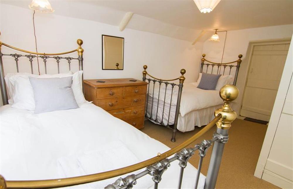 First floor:  Second twin bedroom with full size antiques style brass and metal bed at Hambledon, Cley-next-the-Sea near Holt