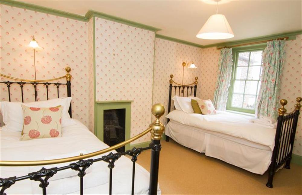 First floor:  Twin bedroom with full size antique style brass and metal beds at Hambledon, Cley-next-the-Sea near Holt