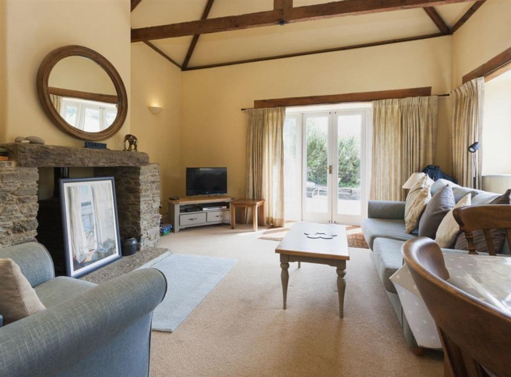 Open plan living space with vaulted and beamed ceilings at Hanger Mill Barn in Salcombe, Devon