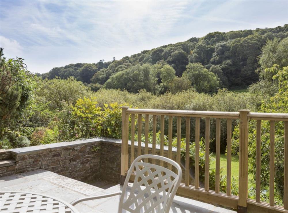 Patio with garden furniture and fantastic valley views (photo 3) at Hanger Mill Barn in Salcombe, Devon
