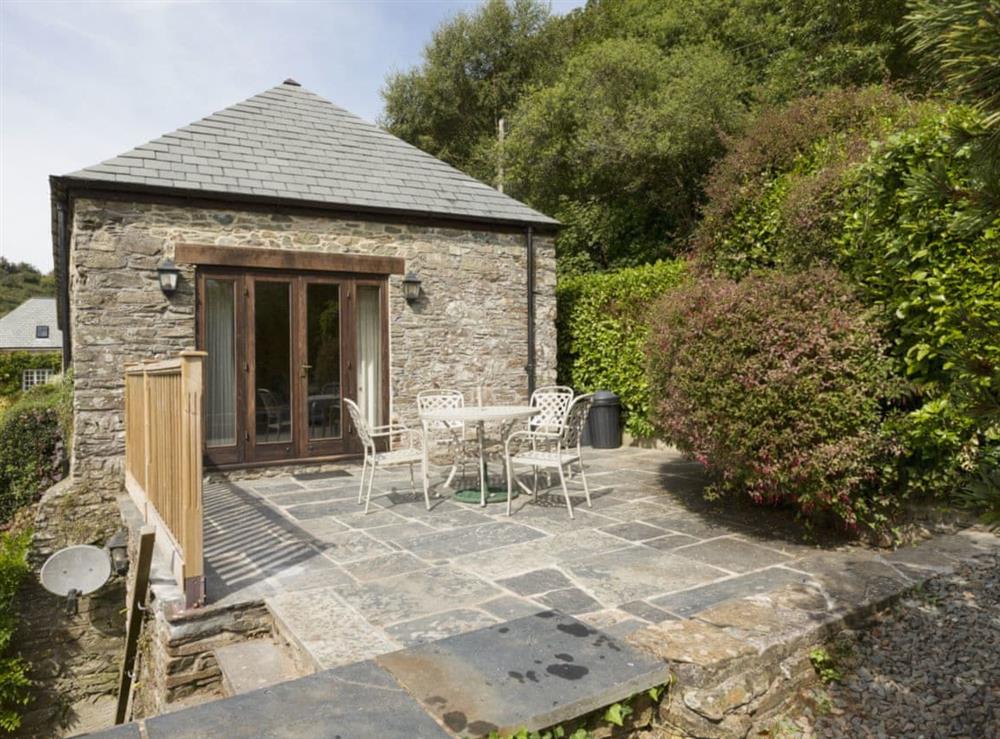 Patio with garden furniture and fantastic valley views at Hanger Mill Barn in Salcombe, Devon