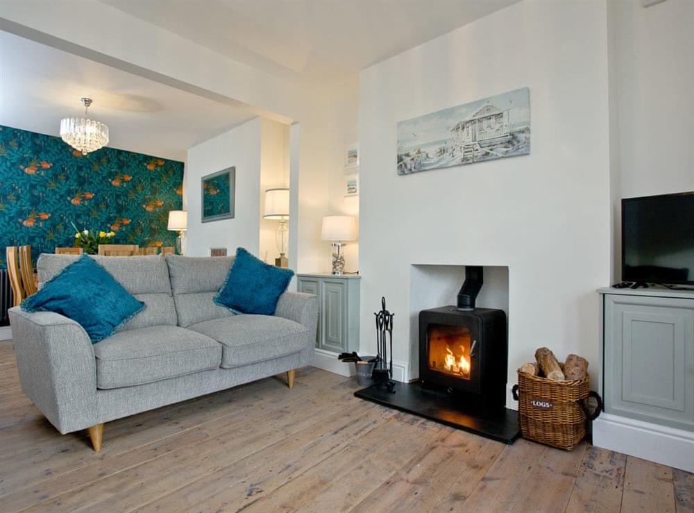 Welcoming living area with wood burner at Happy Place in Brixham, Devon