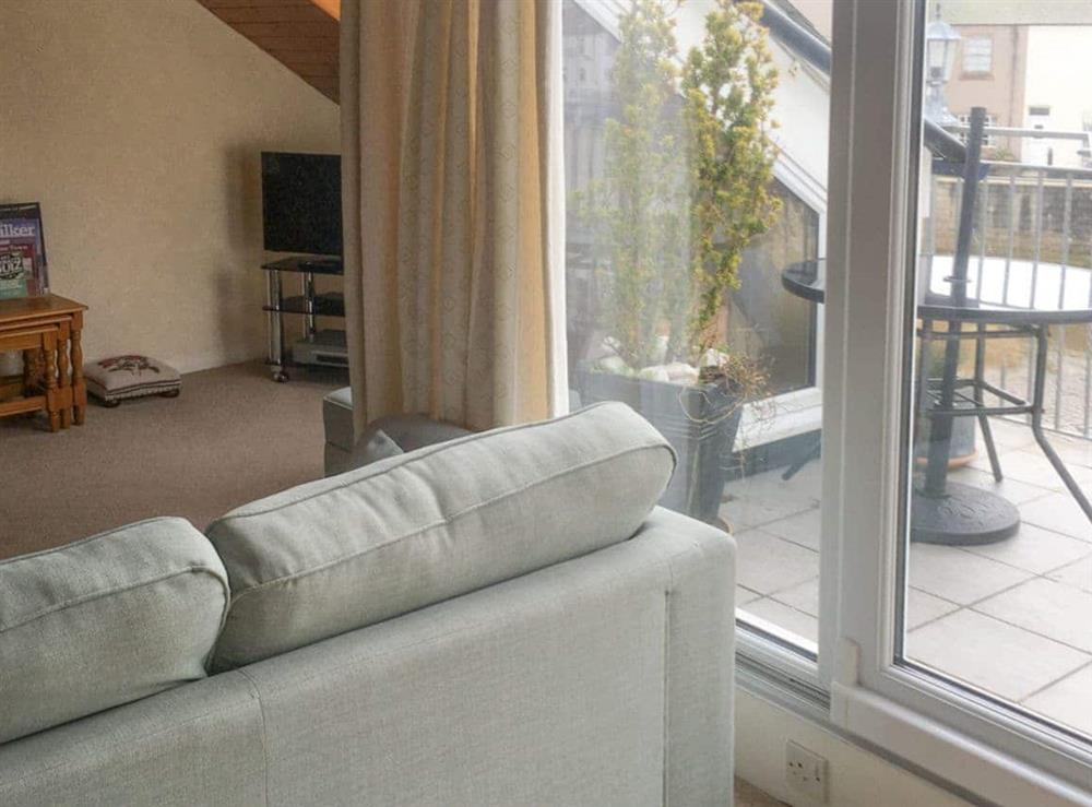 Airy living room with access to the balcony at Harbour Cottage in Haverigg, near Millom, Cumbria