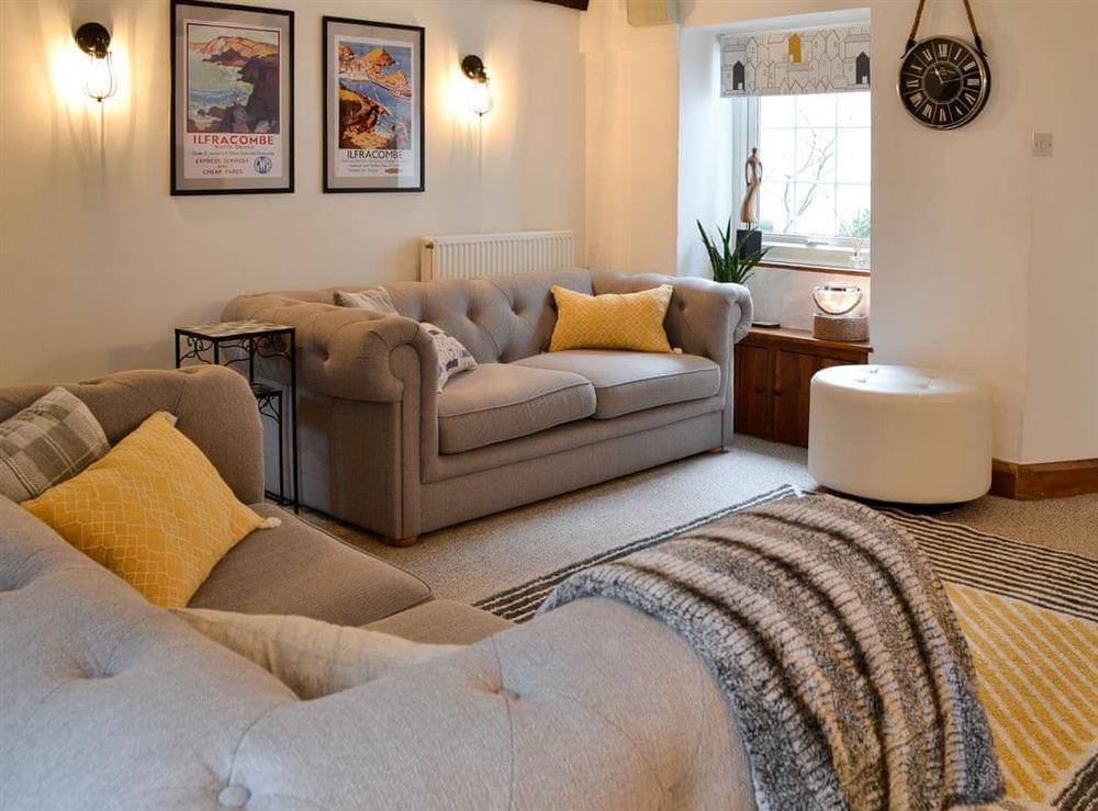 Cosy living room with multi-fuel burner & smart TV (photo 3) at Harbour Hideaway in Ilfracombe, Devon