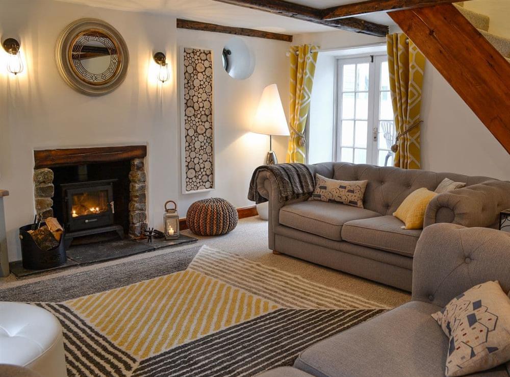 Cosy living room with multi-fuel burner & smart TV at Harbour Hideaway in Ilfracombe, Devon