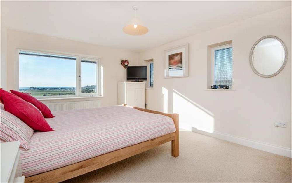 Bedroom 1 with kingsize bed, sea views and ensuite at Harbour Lights in Bridport
