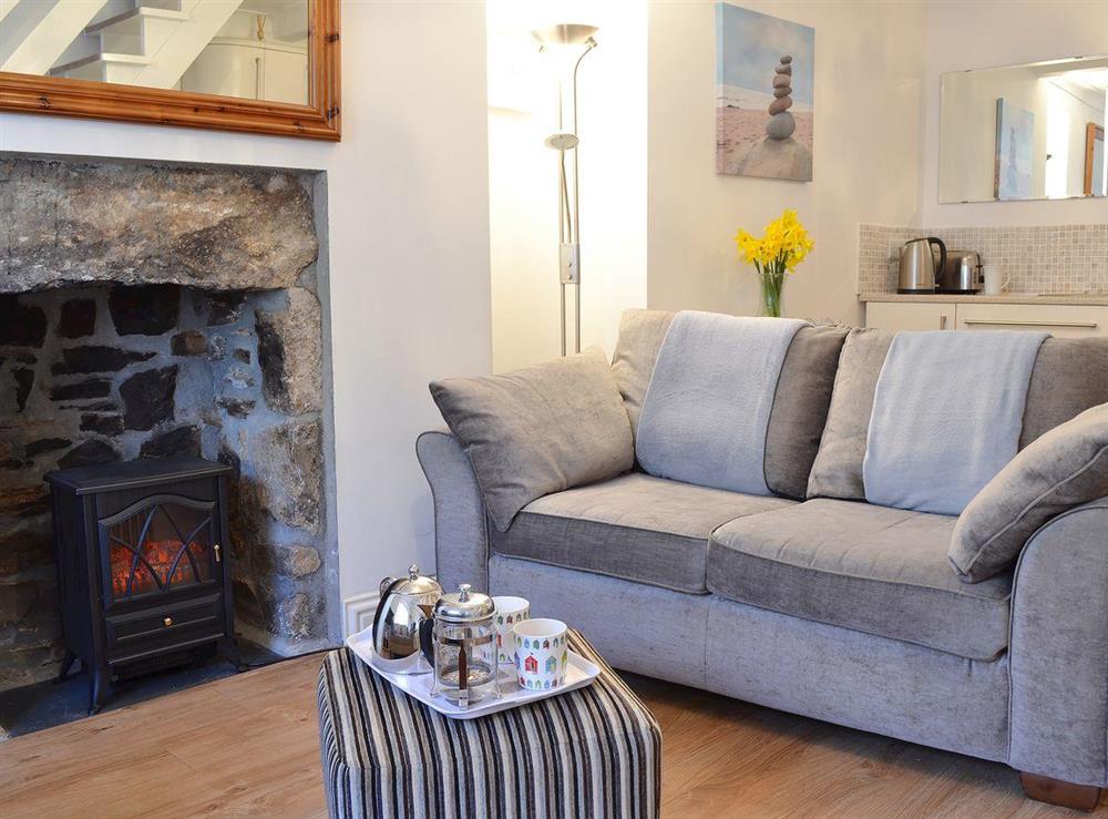 Open plan living area with electric woodburner at Harbour Lights in Newlyn, near Penzance, Cornwall