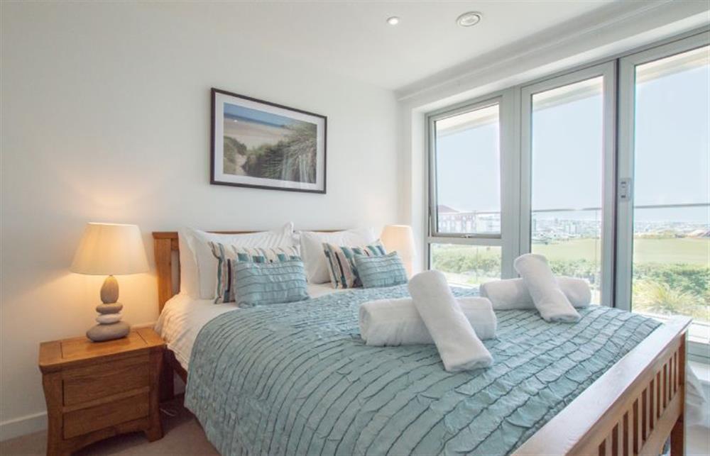 Bedroom one with 5’ king-size bed and doors onto the balcony at Harbour Lights, Newquay 